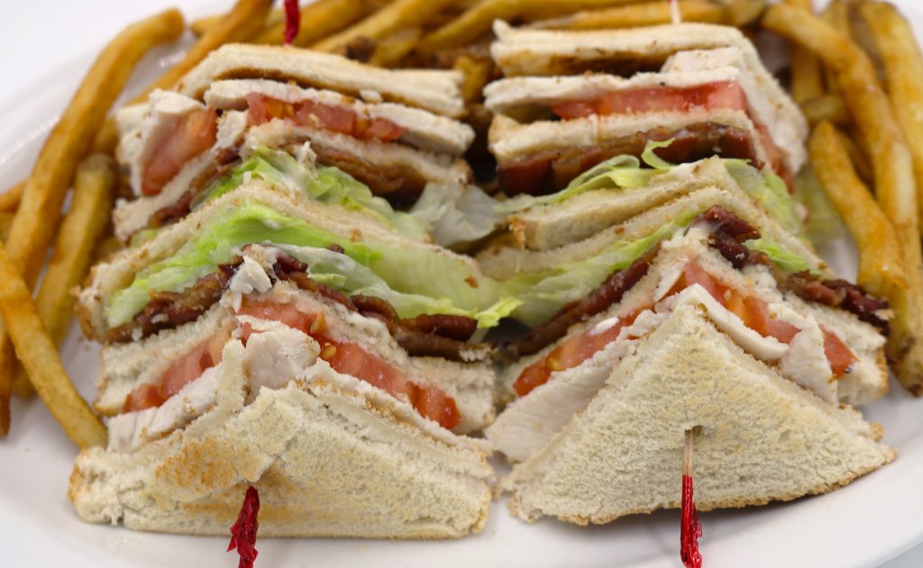 Fireside Welland restaurant clubhouse sandwich with roasted turkey, bacon, lettuce, tomato, mayo and fresh cut fries